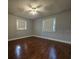 Empty bedroom with gray walls and laminate wood flooring at 908 N Gordon St, Plant City, FL 33563