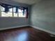 Empty bedroom with gray walls and laminate wood flooring at 908 N Gordon St, Plant City, FL 33563