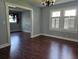 Dining room with hardwood floors and access to the living room at 908 N Gordon St, Plant City, FL 33563