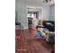 Living room with laminate flooring and a view into another room at 908 N Gordon St, Plant City, FL 33563