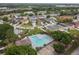 Aerial view of community pool, homes, and surrounding landscape at 915 Burlwood St, Brandon, FL 33511