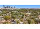 Aerial view of a neighborhood with mature trees, city skyline and coastline in the distance at 979 11Th S Ave, St Petersburg, FL 33705