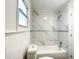 Updated bathroom with marble tile, shower/tub combo, and window at 979 11Th S Ave, St Petersburg, FL 33705