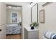 Stylish bathroom featuring a gray vanity, sleek mirror, starfish art, and a serene view into the bedroom at 979 11Th S Ave, St Petersburg, FL 33705
