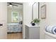 Stylish bathroom featuring a gray vanity, sleek mirror, starfish art, and a serene view into the bedroom at 979 11Th S Ave, St Petersburg, FL 33705