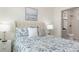 Bedroom featuring a tufted headboard, stylish lamps, and ensuite bathroom at 979 11Th S Ave, St Petersburg, FL 33705