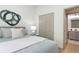 Cozy bedroom with modern decor, including a statement wall art piece and view of the en-suite bathroom at 979 11Th S Ave, St Petersburg, FL 33705