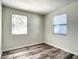 Well-lit bedroom featuring wood-look floors and two windows at 979 11Th S Ave, St Petersburg, FL 33705