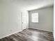 Spacious bedroom with wood-look floors and a window at 979 11Th S Ave, St Petersburg, FL 33705