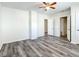 Spacious bedroom with ceiling fan, wood-look floors, and multiple doors at 962 James S Ave, St Petersburg, FL 33705