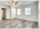 Bright bedroom with hardwood floors, two windows, ceiling fan, and closet space at 979 11Th S Ave, St Petersburg, FL 33705