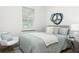 Inviting bedroom featuring a cozy bed, soft lighting, and stylish decor with circle wall art at 979 11Th S Ave, St Petersburg, FL 33705