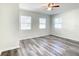 Bedroom with ceiling fan, wood-look floors, and multiple windows at 979 11Th S Ave, St Petersburg, FL 33705