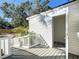 Charming home exterior featuring a wooden deck and white siding with an open door at 962 James S Ave, St Petersburg, FL 33705