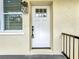 Close-up of the white front door with window and dark hardware at 979 11Th S Ave, St Petersburg, FL 33705