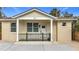 Charming front exterior of home with covered porch and neutral stucco at 979 11Th S Ave, St Petersburg, FL 33705