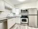 Modern kitchen with white cabinets and stainless steel appliances at 979 11Th S Ave, St Petersburg, FL 33705