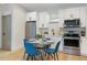 Well-lit kitchen features stainless steel appliances and a dining area with seating for four at 979 11Th S Ave, St Petersburg, FL 33705