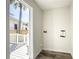 Bright laundry room with wood-look floors and backyard access at 979 11Th S Ave, St Petersburg, FL 33705