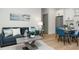 Modern living area with blue sofa, dining area and white kitchen cabinets at 979 11Th S Ave, St Petersburg, FL 33705