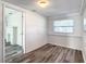 Bright living room featuring light wood floors, white walls, and updated lighting at 979 11Th S Ave, St Petersburg, FL 33705