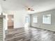 Bright living room featuring light wood floors, white walls, and multiple windows at 979 11Th S Ave, St Petersburg, FL 33705
