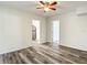 Open floor plan living room with light wood floors, white walls, and access to kitchen at 979 11Th S Ave, St Petersburg, FL 33705