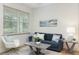 Bright living room with a comfortable blue sofa, modern décor, and large window at 979 11Th S Ave, St Petersburg, FL 33705