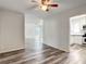 Bright living room featuring modern floors, ceiling fan, and an open layout to the kitchen at 979 11Th S Ave, St Petersburg, FL 33705