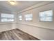 Bright living room featuring light wood floors, white walls, and large windows at 979 11Th S Ave, St Petersburg, FL 33705