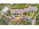 Aerial view of community, showcasing building rooftops, pool, and parking at 10 Aster Pl, Oldsmar, FL 34677