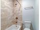 Updated bathroom with beige tile and bathtub at 10 Aster Pl, Oldsmar, FL 34677