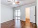Bedroom with hardwood floors and sliding glass doors to patio at 10 Aster Pl, Oldsmar, FL 34677