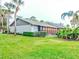 Exterior view showing the side of the house and landscaping at 10 Aster Pl, Oldsmar, FL 34677