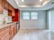 Eat-in kitchen with wood cabinets and tile flooring at 10 Aster Pl, Oldsmar, FL 34677