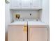 Laundry room with side-by-side washer and dryer at 10 Aster Pl, Oldsmar, FL 34677