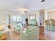 Living room with light green furniture and hardwood floors at 10 Aster Pl, Oldsmar, FL 34677