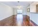 Spacious living room with hardwood floors and sliding glass doors leading to a patio at 10 Aster Pl, Oldsmar, FL 34677