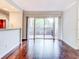 Living room with hardwood floors and sliding glass doors leading to a patio at 10 Aster Pl, Oldsmar, FL 34677