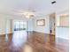 Living room with hardwood floors and sliding glass doors leading to a patio at 10 Aster Pl, Oldsmar, FL 34677