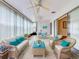 Sunroom with wicker furniture and light blue accents at 10 Aster Pl, Oldsmar, FL 34677