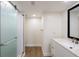 Bathroom with glass shower, white vanity, and wood-look floors at 100 Oakmont Ln # 309, Belleair, FL 33756