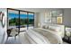 Main bedroom with balcony access and leafy view at 100 Oakmont Ln # 309, Belleair, FL 33756