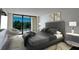 Main bedroom with king-size bed, balcony access, and modern decor at 100 Oakmont Ln # 309, Belleair, FL 33756