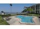 Community pool with patio furniture and waterfront views at 100 Oakmont Ln # 309, Belleair, FL 33756