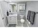 Updated bathroom with white vanity, marble countertop, and gray accents at 1001 S Bayshore Blvd # 205, Safety Harbor, FL 34695