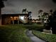 Building exterior at night, showing landscaping and a lighted walkway at 1001 S Bayshore Blvd # 205, Safety Harbor, FL 34695