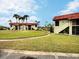 Two-story condo building with red tile roofs and lush landscaping at 1001 S Bayshore Blvd # 205, Safety Harbor, FL 34695