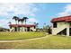Community features lush landscaping, a walkway, and attractive building exteriors at 1001 S Bayshore Blvd # 205, Safety Harbor, FL 34695