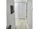 Hallway with white doors and light wood flooring at 1001 S Bayshore Blvd # 205, Safety Harbor, FL 34695